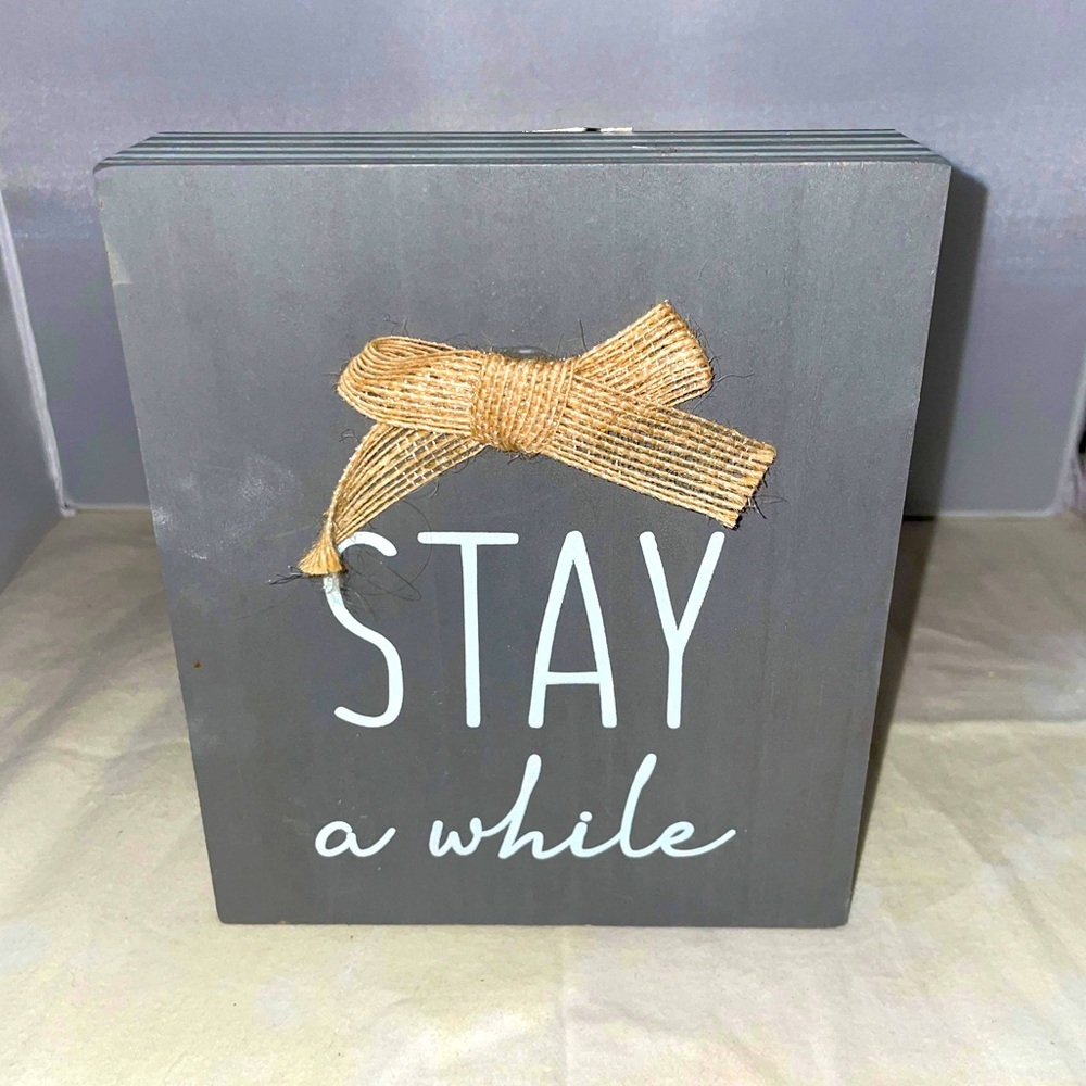 Rustic farmhouse “Stay a while” wall hanging with burlap bow